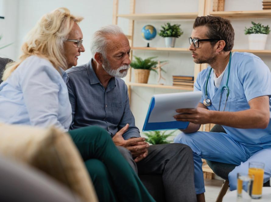 general-practitioner-showing-senior-couple-medical-documents-while-being-home-visit