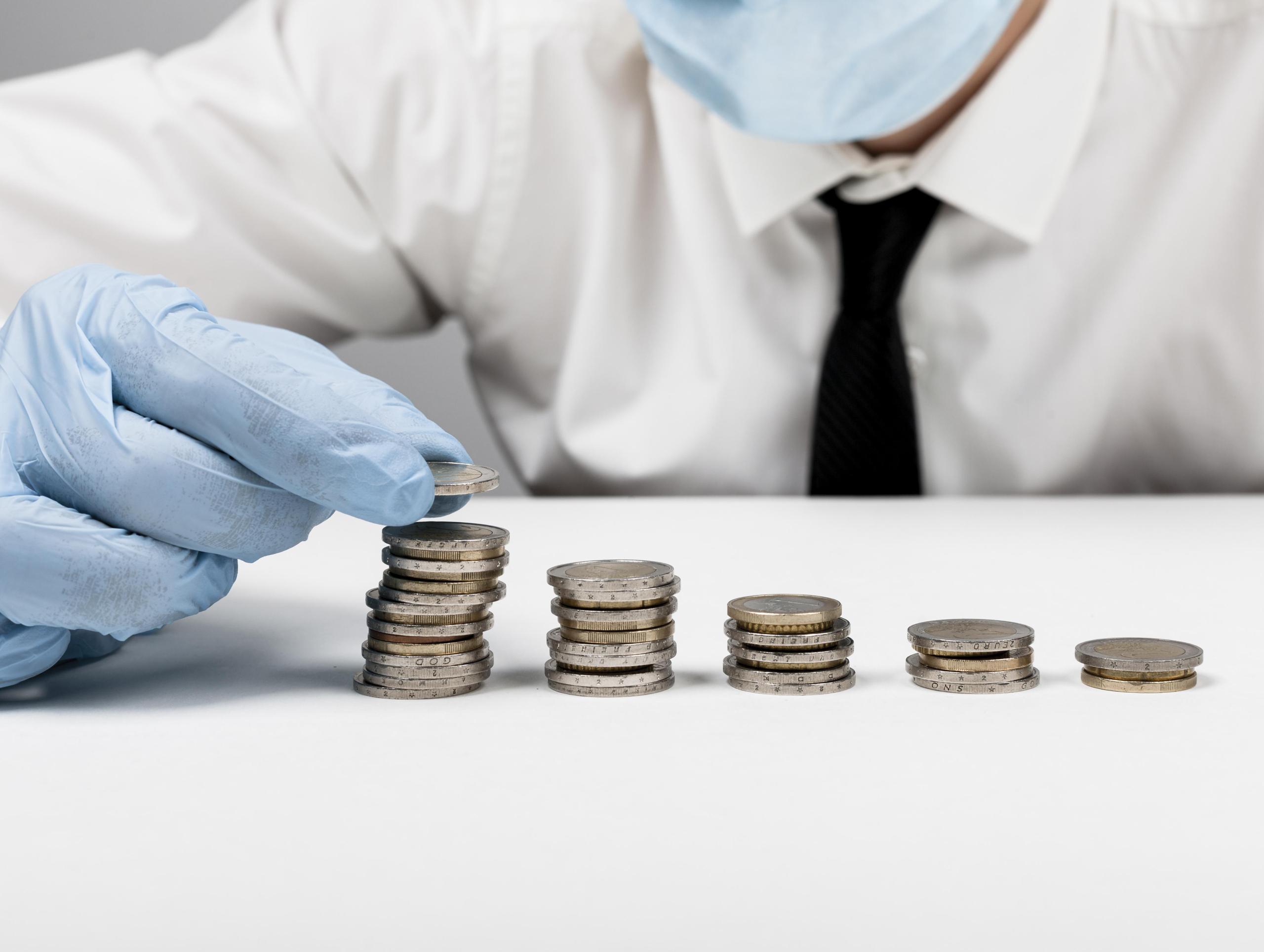 piles-coins-man-wearing-protection-gloves